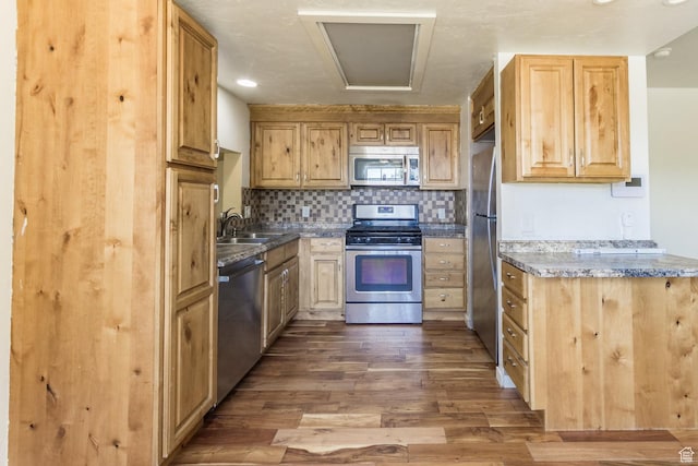 168 S 100 W, Roosevelt, UT 84066 - kitchen with appliances with stainless steel finishes, dark wood-style flooring, backsplash, and light brown cabinets
