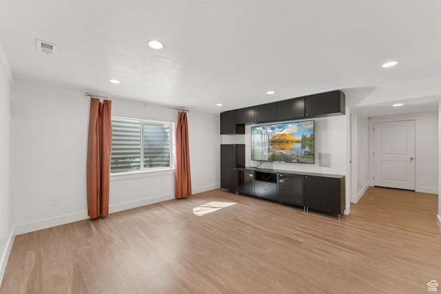 2886 N Desert Forest Ln, Lehi, UT 84043 - unfurnished living room featuring light wood-style flooring and recessed lighting