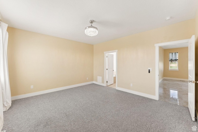 2886 N Desert Forest Ln, Lehi, UT 84043 - unfurnished room with light colored carpet, a chandelier, and a smoke detector