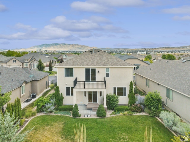 2886 N Desert Forest Ln, Lehi, UT 84043 - rear view of property featuring a balcony, a residential view, stucco siding, a yard, and a shingled roof