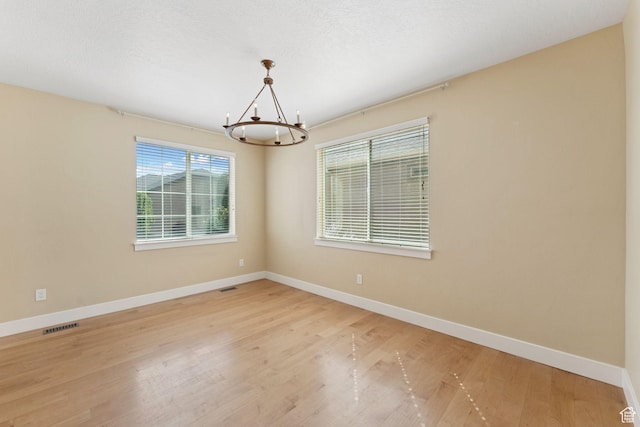 2886 N Desert Forest Ln, Lehi, UT 84043 - unfurnished room featuring a chandelier and light wood-style flooring