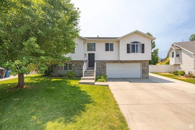 232 Sunstone Cir W, Logan, UT 84321 - split foyer home with a garage, concrete driveway, and brick siding