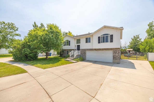 232 Sunstone Cir W, Logan, UT 84321 - split foyer home with driveway, an attached garage, and brick siding