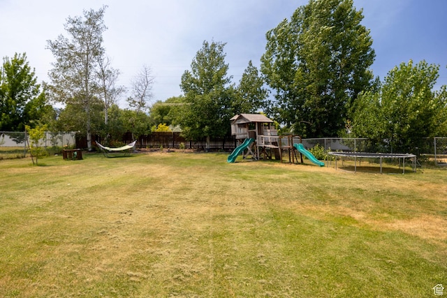232 Sunstone Cir W, Logan, UT 84321 - fenced backyard with a trampoline and a playground