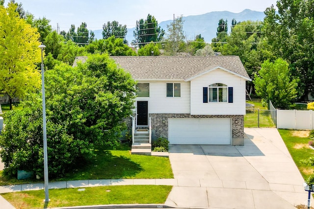 232 Sunstone Cir W, Logan, UT 84321 - split foyer home with a garage, driveway, and brick siding