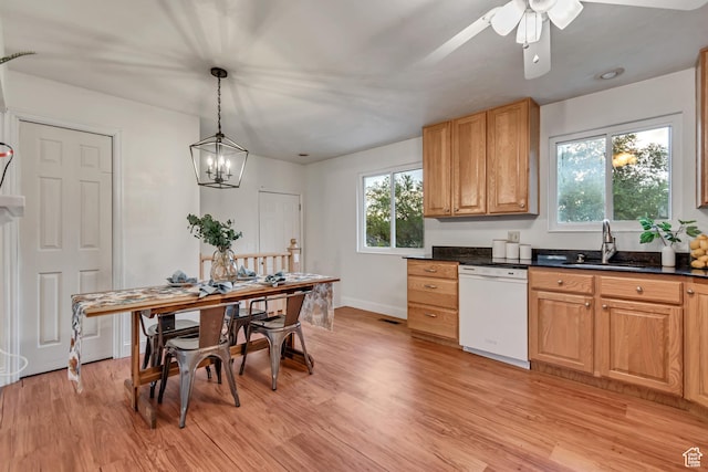 6074 W Wending Ln, West Valley City, UT 84128 - kitchen featuring white dishwasher, dark countertops, plenty of natural light, and light wood finished floors