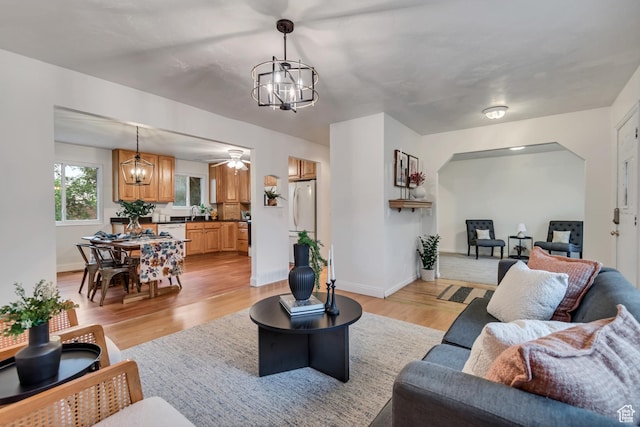 6074 W Wending Ln, West Valley City, UT 84128 - living area with a chandelier and light wood-type flooring