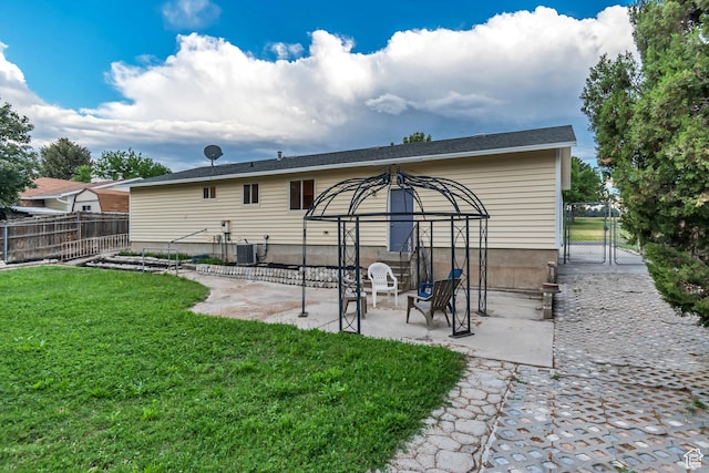 6074 W Wending Ln, West Valley City, UT 84128 - back of property with a gate, a patio area, and a gazebo
