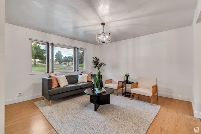 6074 W Wending Ln, West Valley City, UT 84128 - living room with light wood-style floors and a chandelier