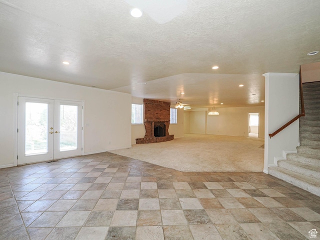 1539 S 50 E, Salem, UT 84653 - unfurnished living room with stairs, recessed lighting, a fireplace, french doors, and a textured ceiling