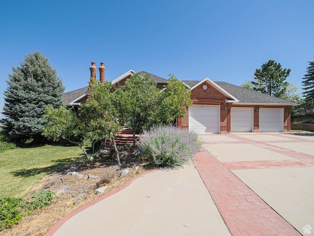 1539 S 50 E, Salem, UT 84653 - view of front of home with brick siding, concrete driveway, a garage, a front yard, and a chimney
