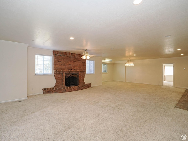 1539 S 50 E, Salem, UT 84653 - unfurnished living room with recessed lighting, plenty of natural light, ceiling fan, a brick fireplace, and carpet floors