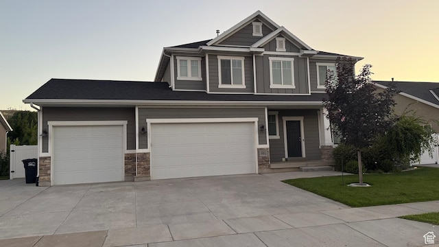 559 E Petersen Pkwy, South Weber, UT 84405 - craftsman inspired home with concrete driveway, stone siding, a yard, board and batten siding, and an attached garage