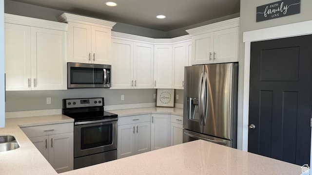 559 E Petersen Pkwy, South Weber, UT 84405 - kitchen featuring stainless steel appliances, recessed lighting, white cabinetry, and light stone counters