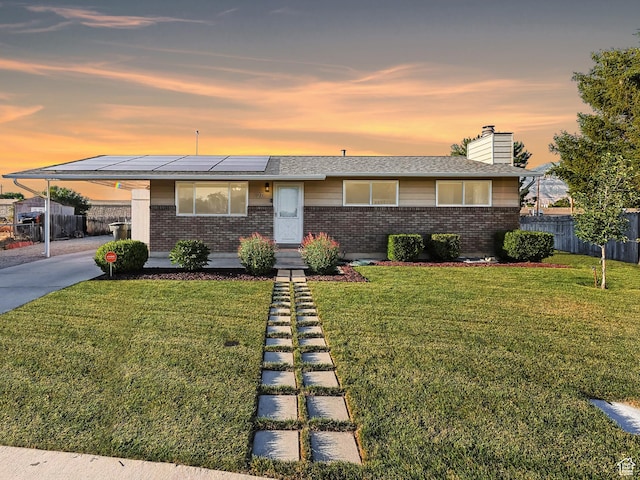 271 S Barratt Cir, American Fork, UT 84003 - mid-century inspired home featuring brick siding, a chimney, solar panels, a carport, and concrete driveway
