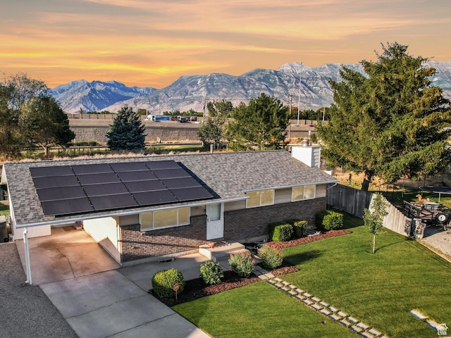 271 S Barratt Cir, American Fork, UT 84003 - view of front of house with brick siding, a mountain view, roof mounted solar panels, and a shingled roof