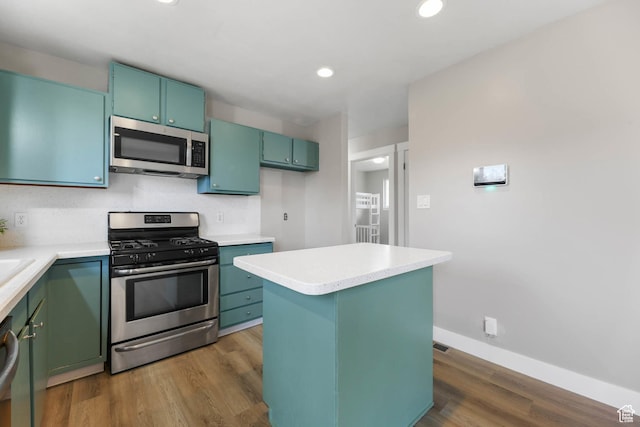 271 S Barratt Cir, American Fork, UT 84003 - kitchen with stainless steel appliances, dark wood-style flooring, light countertops, recessed lighting, and a kitchen island