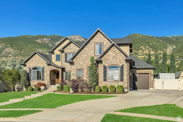 789 Eliza Ct, Farmington, UT 84025 - craftsman-style house featuring a gate, concrete driveway, a mountain view, a garage, and stone siding