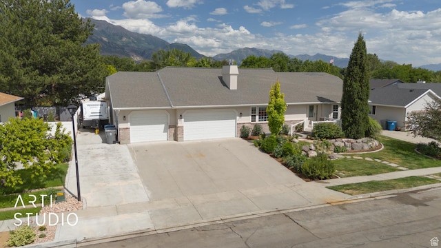 796 N 200 W, American Fork, UT 84003 - view of front of property with a garage, a chimney, concrete driveway, and a mountain view