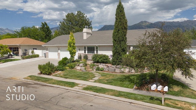 796 N 200 W, American Fork, UT 84003 - view of front of house with a garage, driveway, a mountain view, and a chimney