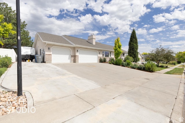 796 N 200 W, American Fork, UT 84003 - view of property exterior featuring an attached garage, driveway, brick siding, and a chimney