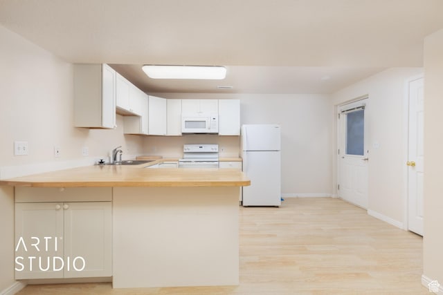 796 N 200 W, American Fork, UT 84003 - kitchen with white appliances, a peninsula, light wood-style floors, wood counters, and white cabinets