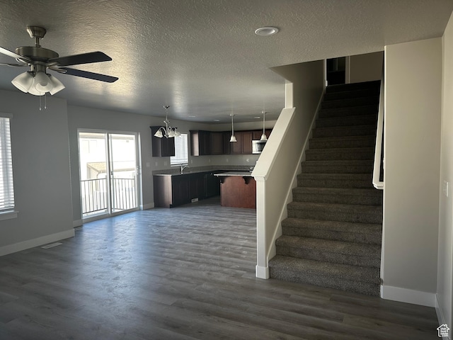 12343 S Varitek Dr, Herriman, UT 84096 - stairs featuring a textured ceiling, ceiling fan, wood finished floors, and a chandelier