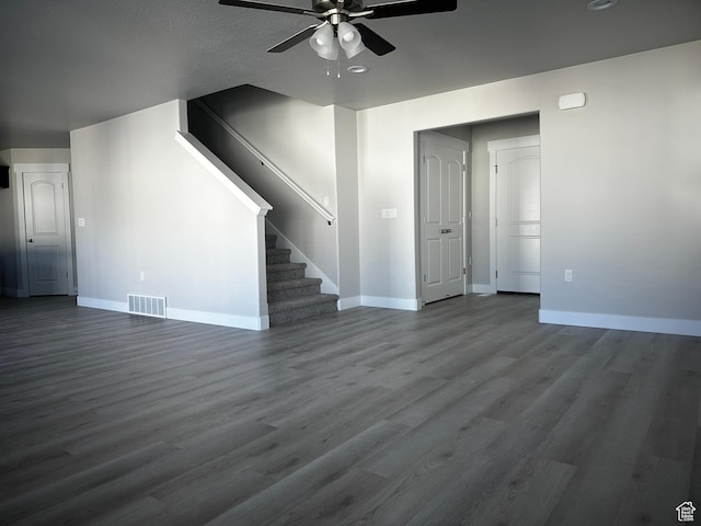 12343 S Varitek Dr, Herriman, UT 84096 - unfurnished living room featuring ceiling fan, stairway, and dark wood-style floors