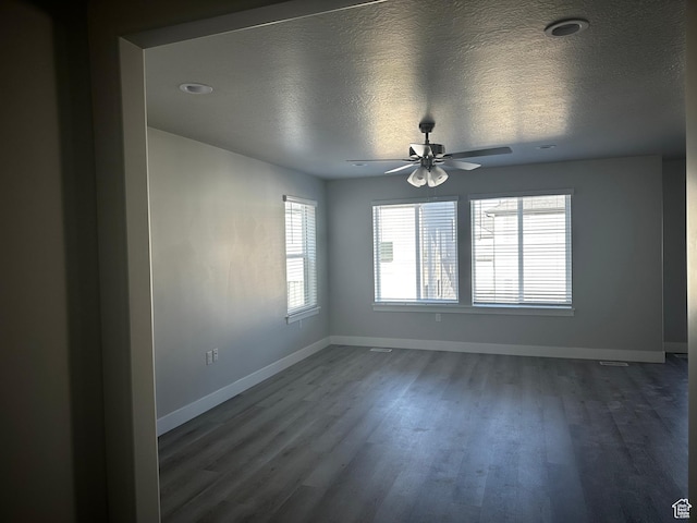 12343 S Varitek Dr, Herriman, UT 84096 - spare room featuring dark wood-style floors, ceiling fan, and a textured ceiling