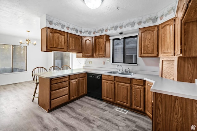458 E 200 S, Annabella, UT 84711 - kitchen with black dishwasher, a peninsula, brown cabinetry, a chandelier, and a textured ceiling