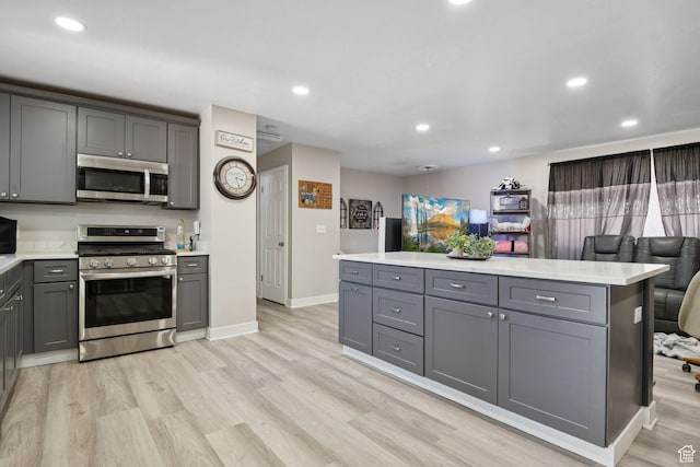 4807 S Heath Ave W, Salt Lake City, UT 84118 - kitchen featuring appliances with stainless steel finishes, gray cabinetry, light countertops, light wood-style floors, and recessed lighting