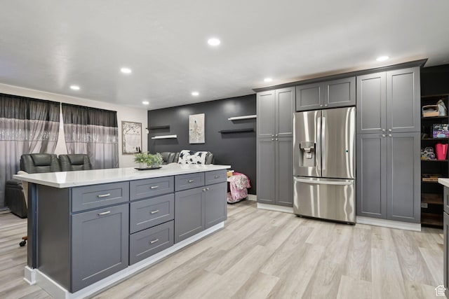 4807 S Heath Ave W, Salt Lake City, UT 84118 - kitchen with stainless steel fridge with ice dispenser, gray cabinetry, light countertops, light wood-style floors, and recessed lighting