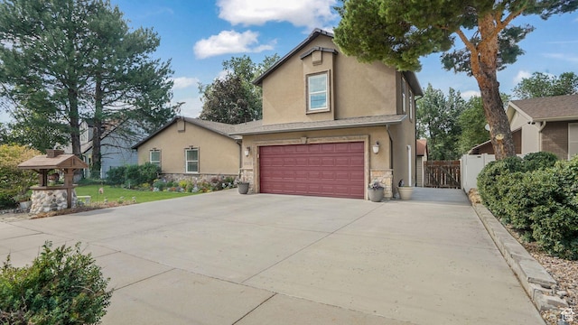 2275 E 9800 S, Sandy, UT 84092 - view of front of house featuring stone siding, a garage, stucco siding, and concrete driveway
