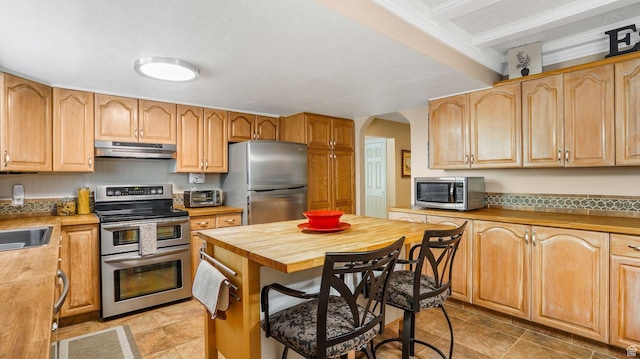 2275 E 9800 S, Sandy, UT 84092 - kitchen with stainless steel appliances, butcher block countertops, under cabinet range hood, arched walkways, and a breakfast bar area