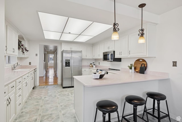 48 W 300 S Unit 1405N, Salt Lake City, UT 84101 - kitchen with stainless steel appliances, a peninsula, white cabinetry, and light countertops