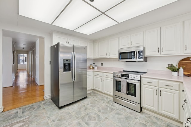 48 W 300 S Unit 1405N, Salt Lake City, UT 84101 - kitchen with stainless steel appliances, light countertops, white cabinets, and light wood-type flooring