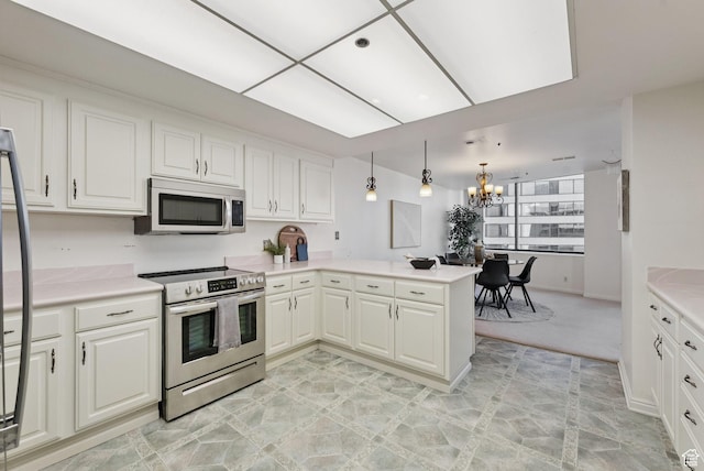 48 W 300 S Unit 1405N, Salt Lake City, UT 84101 - kitchen with stainless steel electric range oven, a chandelier, a peninsula, white cabinets, and light countertops