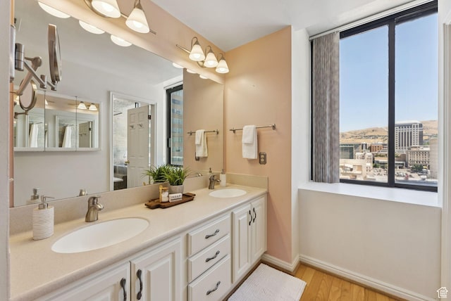 48 W 300 S Unit 1405N, Salt Lake City, UT 84101 - full bathroom featuring wood finished floors, healthy amount of natural light, and double vanity