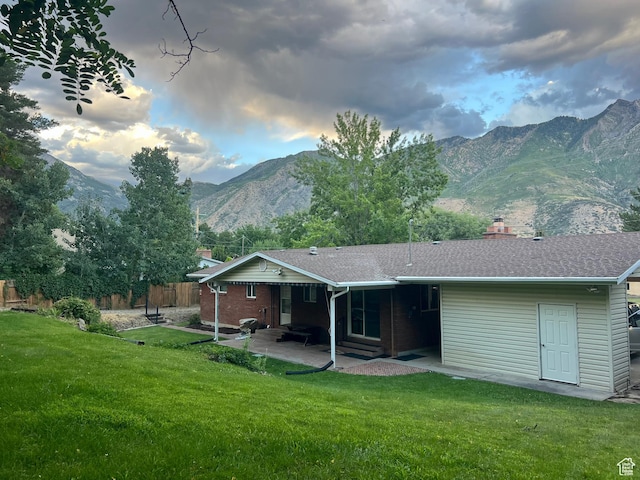 521 N Grove Dr, Alpine, UT 84004 - back of property with a chimney, a patio area, a mountain view, and roof with shingles
