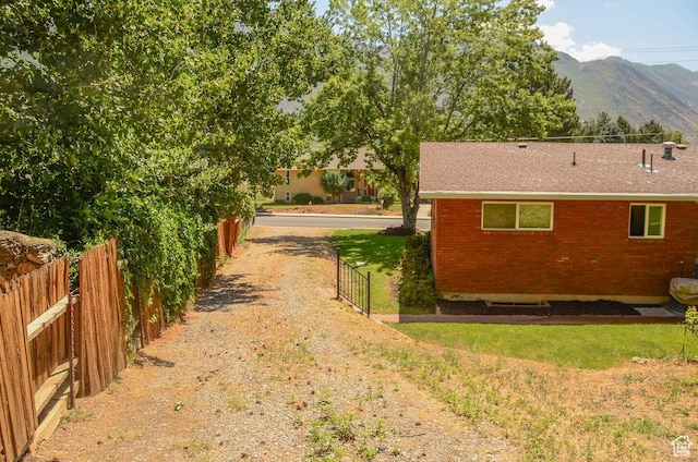 521 N Grove Dr, Alpine, UT 84004 - view of side of property featuring a mountain view, brick siding, and roof with shingles