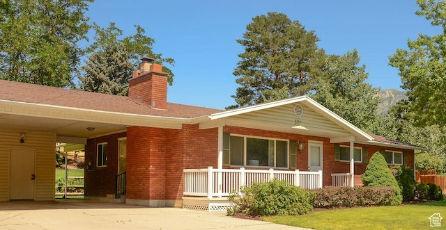 521 N Grove Dr, Alpine, UT 84004 - ranch-style home with a porch, a chimney, brick siding, concrete driveway, and a front yard
