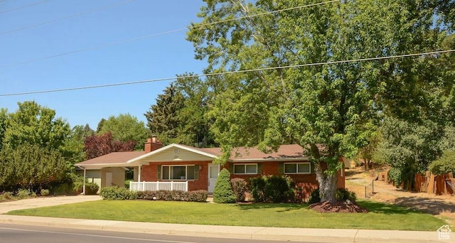521 N Grove Dr, Alpine, UT 84004 - ranch-style home with a front yard, driveway, a porch, brick siding, and a chimney