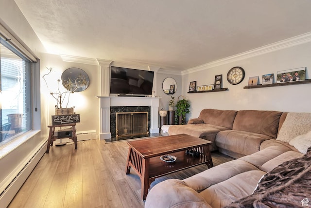 3161 S 8520 W, Magna, UT 84044 - living area with a baseboard heating unit, hardwood / wood-style flooring, crown molding, and a high end fireplace