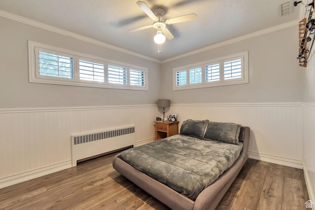 3161 S 8520 W, Magna, UT 84044 - bedroom with radiator heating unit, wainscoting, wood finished floors, ornamental molding, and a ceiling fan