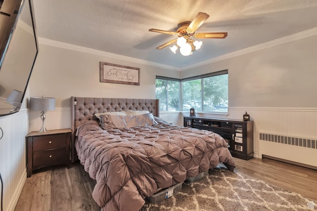 3161 S 8520 W, Magna, UT 84044 - bedroom featuring radiator heating unit, a wainscoted wall, wood finished floors, ornamental molding, and ceiling fan