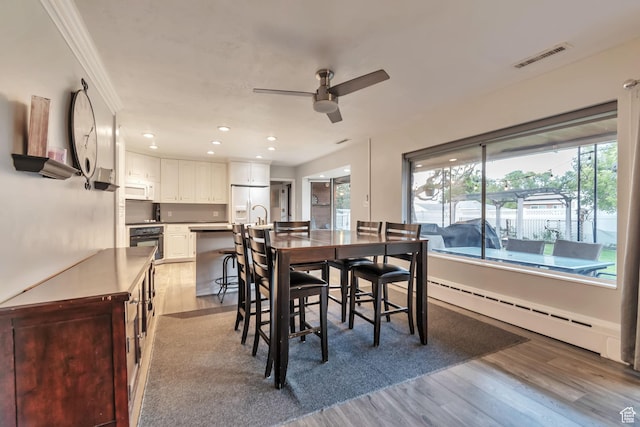 3161 S 8520 W, Magna, UT 84044 - dining area with a baseboard heating unit, healthy amount of natural light, a ceiling fan, wood finished floors, and recessed lighting