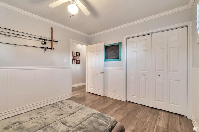 3161 S 8520 W, Magna, UT 84044 - bedroom featuring wood finished floors, crown molding, a closet, a wainscoted wall, and a ceiling fan