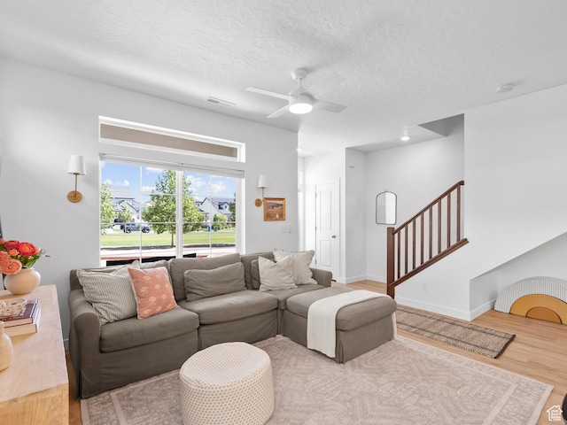132 E Geyser Ct, Saratoga Springs, UT 84045 - living room with ceiling fan, wood finished floors, stairs, and a textured ceiling