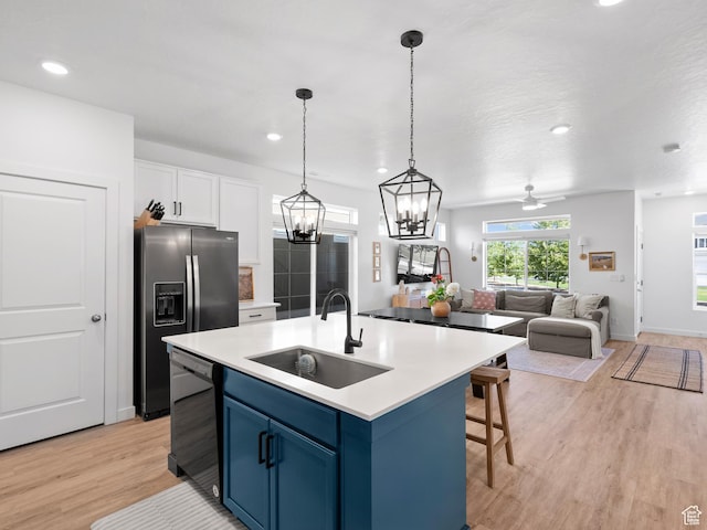 132 E Geyser Ct, Saratoga Springs, UT 84045 - kitchen with dishwasher, blue cabinetry, light wood-type flooring, white cabinetry, and stainless steel fridge