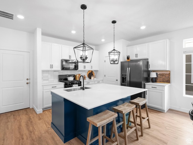 132 E Geyser Ct, Saratoga Springs, UT 84045 - kitchen featuring black appliances, decorative backsplash, light wood finished floors, light countertops, and recessed lighting